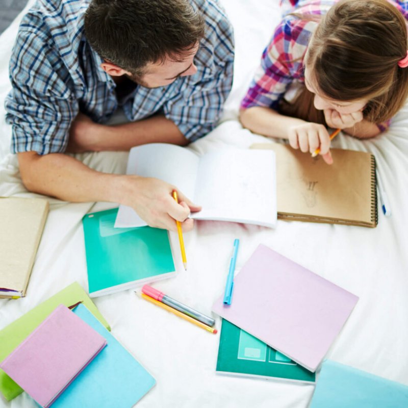 Man helping his teenage daughter to do creative homework